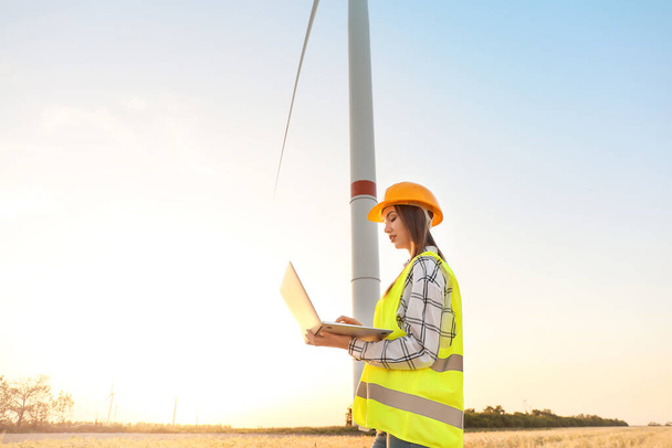 Female engineer on windmill farm for electric power production - Фото, зображення