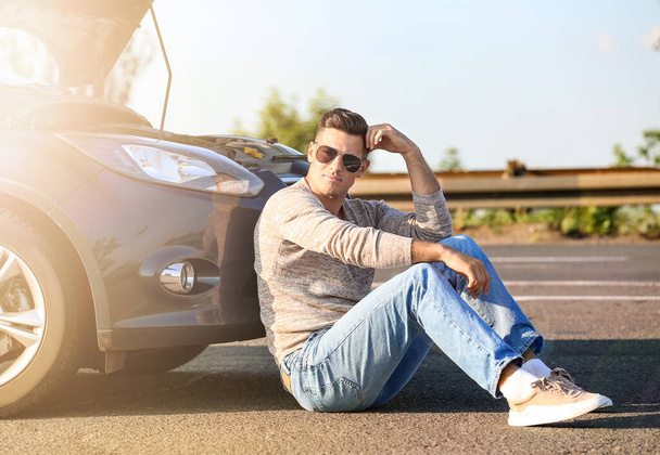 Young man near broken car on road - Photo, Image