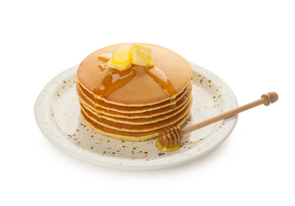 Tasty pancakes with honey and butter on white background - Photo, Image
