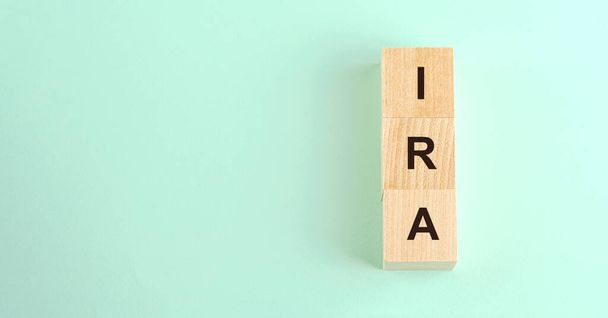 black letters ira on small wooden cubes and space for text - Foto, Imagen