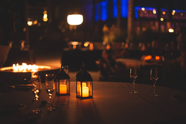 night photo with candles lights on tables - Foto, imagen