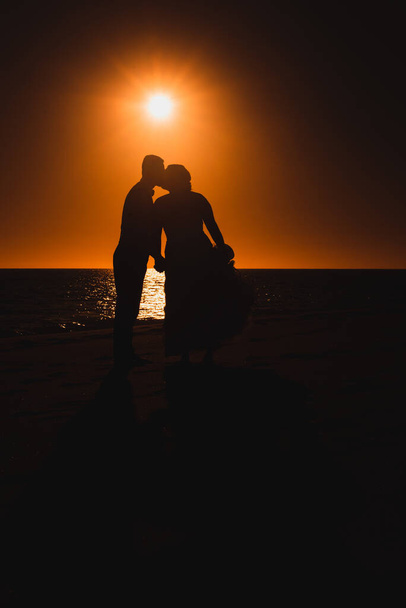 couple in love against sunset sky kissing  - Photo, Image