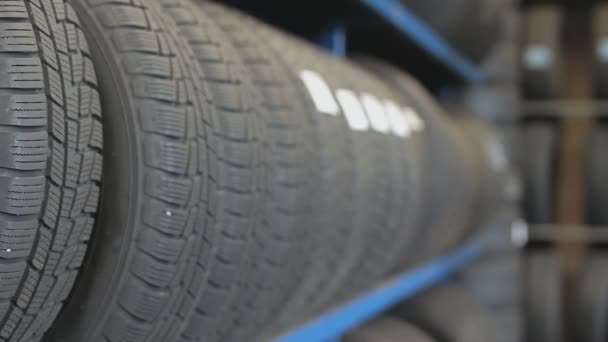 Rack of new car tires in a garage. Panorama shot - Footage, Video