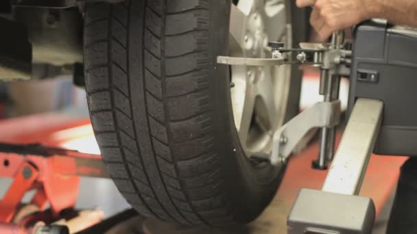 Alignment machine is placed on a tire in a garage - Footage, Video