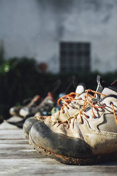 A soft focus of old grungy rubber shoes against a blurry background - 写真・画像