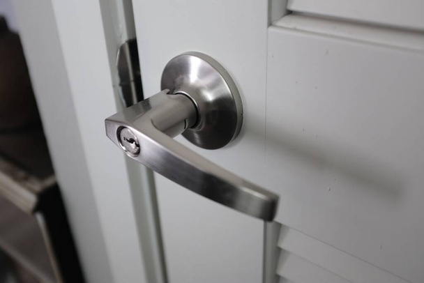 A closeup of door handle -- stainless steel material - Foto, imagen