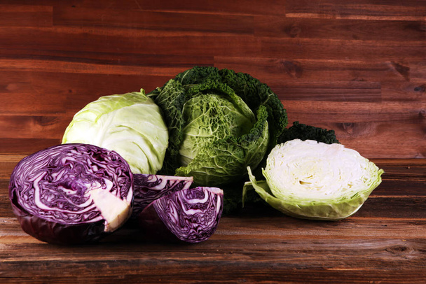 Three fresh organic cabbage heads. Antioxidant balanced diet eating with red cabbage, white cabbage and fresh savoy - Фото, зображення