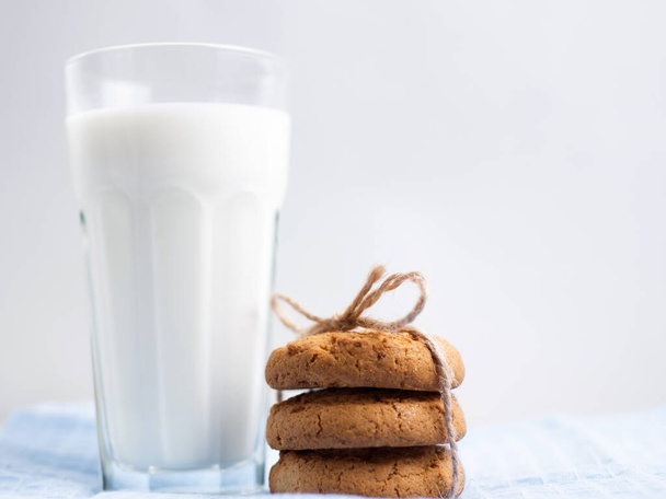 Glass of milk and cookies on wooden white background - Photo, image