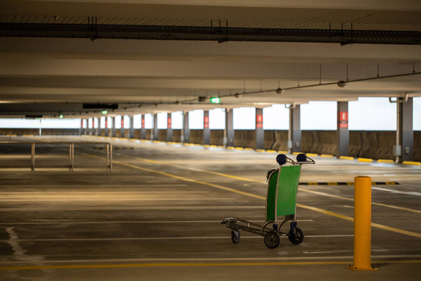 An empty airport car park during the corona COVID-19 pandemic, trolley cart stands abandoned - Photo, Image