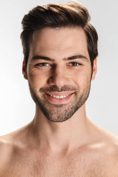 Photo of pleased half-naked man smiling and looking at camera isolated over white background - Photo, Image