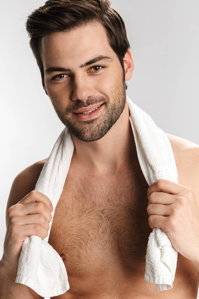 Photo of happy half-naked man posing with towel and smiling isolated over white background - Φωτογραφία, εικόνα