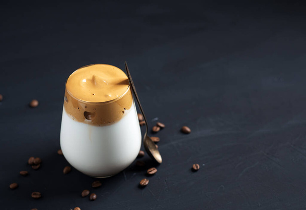 Dalgona dessert cream coffee in a glass on a dark concrete table - Photo, Image