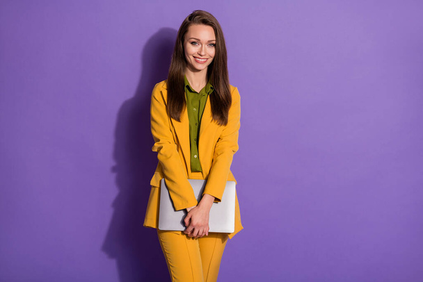 Photo of attractive confident business lady hold laptop hands successful person work online meeting wear yellow office blazer trousers suit shirt isolated purple pastel color background - Foto, imagen