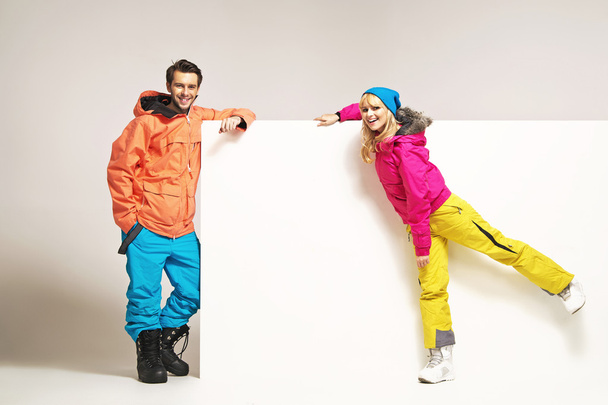 Attractive couple wearing colorful winter clothes - Fotó, kép