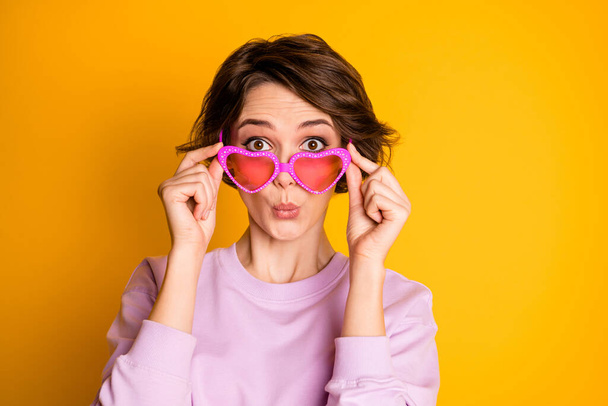 Close up photo of astonished youth girl look good incredible bargain news information cant believe her eyes touch heart shape specs wear pullover isolated over vibrant color background - Valokuva, kuva