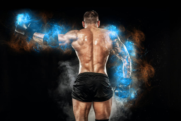 Athlete bodybuilder in blue energy lights. Boxing man posing on black background. Sporty guy male . Fitness muscled man. Sport concept - Φωτογραφία, εικόνα