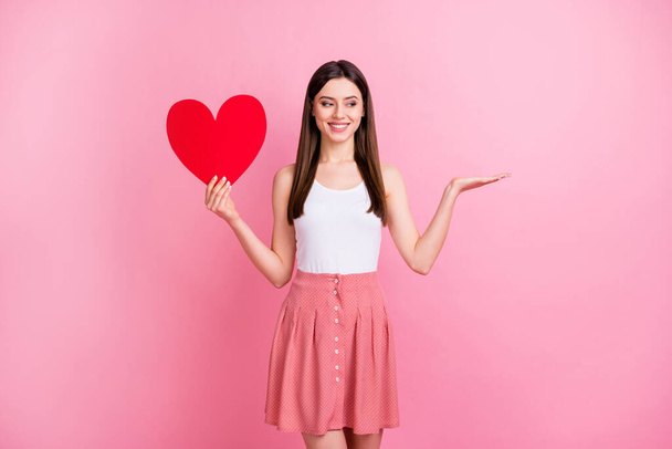 Portrait of her she nice-looking attractive lovely charming cheerful cheery straight-haired girl holding in hand paper card copy space on palm isolated over pink pastel color background - 写真・画像