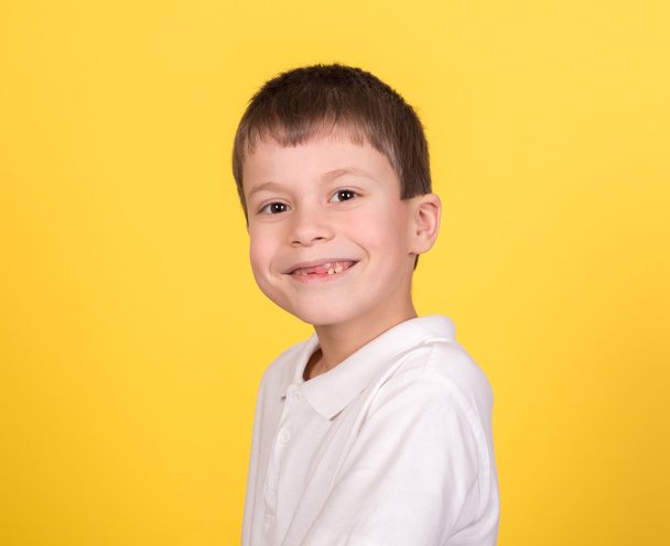 boy portrait in white shirt on yellow - Photo, Image