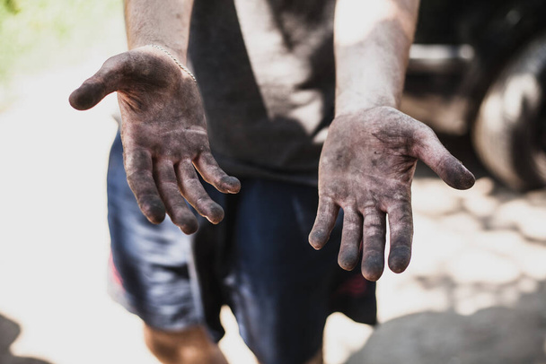 Dirty hands of worker miner are corns palms in abrasions. Concept hard work - Фото, изображение