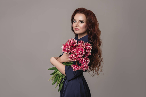 Mother's day concept. Portrait of charming cute lovely with toothy smile woman holding nice bouquet of beautiful  tulips isolated on gray background.fashion and beauty concept. - Foto, immagini