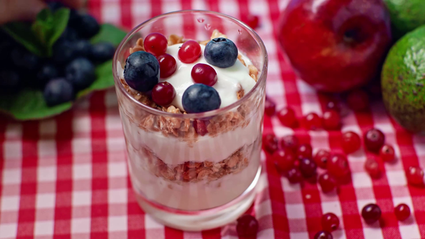selective focus of man adding cranberries in fresh yogurt - Footage, Video
