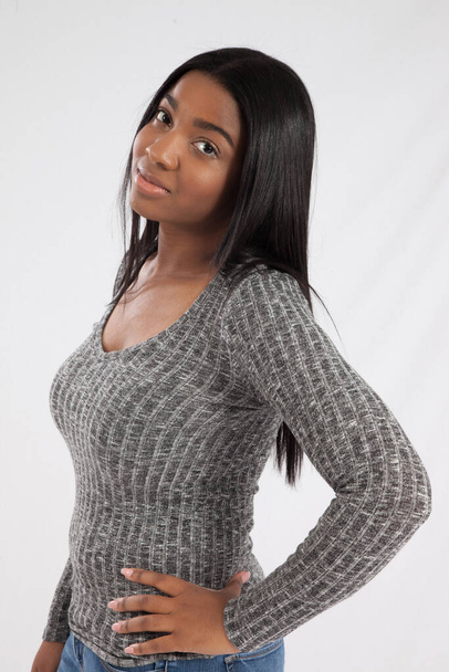 Happy Black woman in a grey sweater - Фото, изображение
