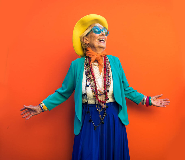 Happy and playful senior woman having fun - Portrait of a beautiful lady above 70 years old with stylish clothes, concepts about senior people - Valokuva, kuva