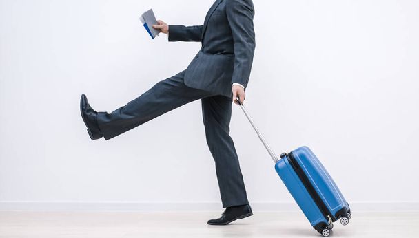 Cropped shot of successful businessman at airport pulling trolley bags ready for international business trip. - 写真・画像
