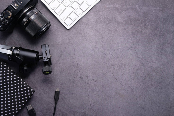 Flat lay camera and equipment on working desk. - Photo, Image