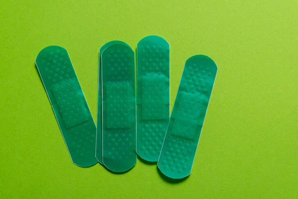 Set of colored first aid plasters on color background - Foto, Imagen