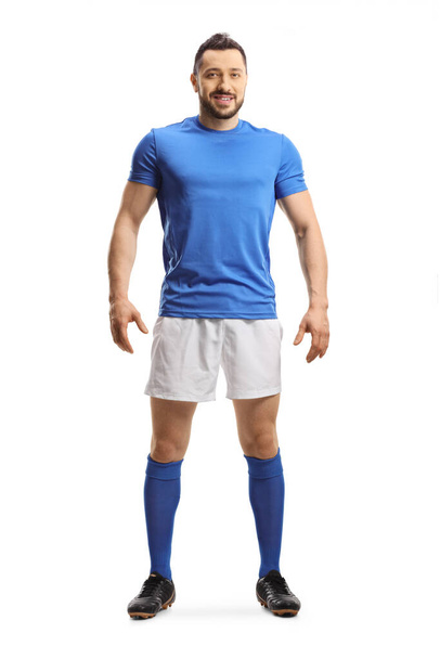Full length portrait of a footballer in a blue top and white shorts isolated on white background - Photo, image