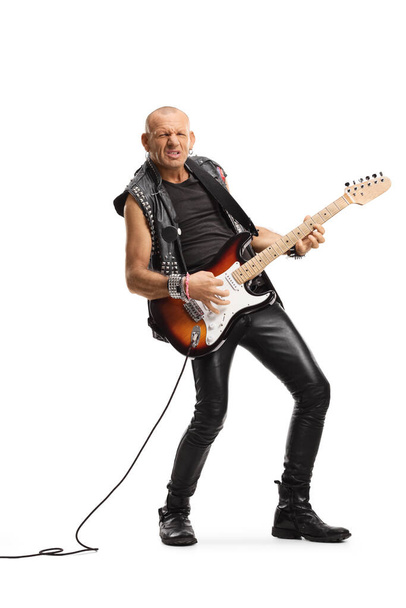 Full length portrait of a punk rocker playing an electric guitar isolated on white background - Foto, Imagen