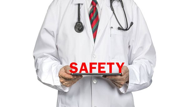 A doctor in white hospital gown holding safety banner.  Isolated on white background. Health issue. Hospital standards. Safety and Quality concept. - Photo, Image