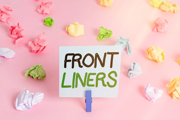Word writing text Frontliners. Business concept for most important or influential position in a debate or movement. Colored crumpled papers empty reminder pink floor background clothespin. - Photo, Image