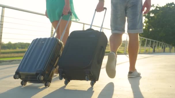 LOW ANGLE: Newly engaged digital nomads carry their luggage before departing. - Footage, Video