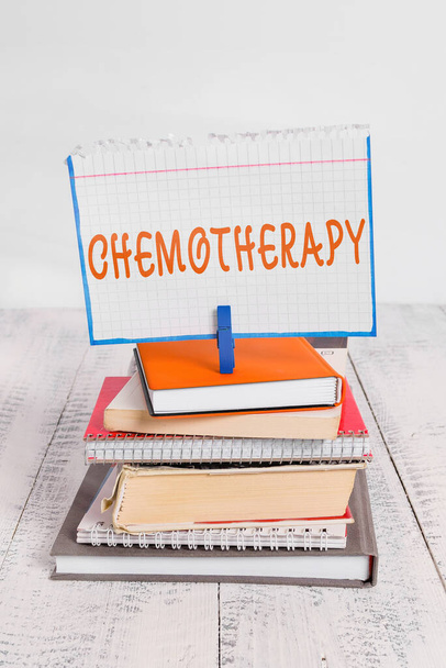 Text sign showing Chemotherapy. Conceptual photo the treatment of disease by the use of chemical substances pile stacked books notebook pin clothespin colored reminder white wooden. - Photo, Image
