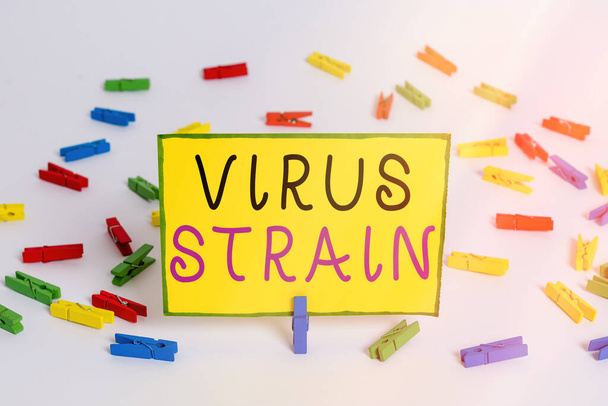Writing note showing Virus Strain. Business photo showcasing Another genetic variant derived from the original microorganism Colored clothespin papers empty reminder white floor background office. - Photo, Image