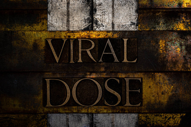 Viral Dose text formed with real authentic typeset letters on vintage textured silver grunge copper and gold background - Photo, Image