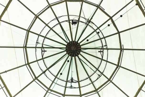 Round glass roof of a building interior. Circular window from a construction interior used for ventilation. Beautiful decorative dome of s gallery or mall- - Photo, Image
