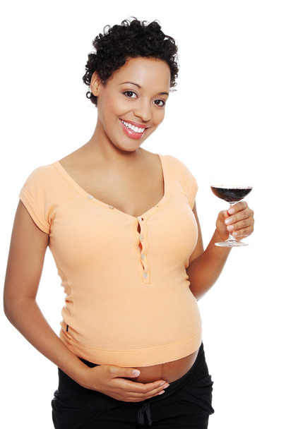 Pregnant woman holding glass wine - 写真・画像