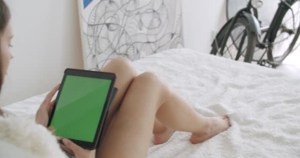 Girl holding tablet computer with green screen - Filmagem, Vídeo