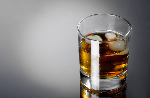 Glass whisky on a grey bg - Fotó, kép