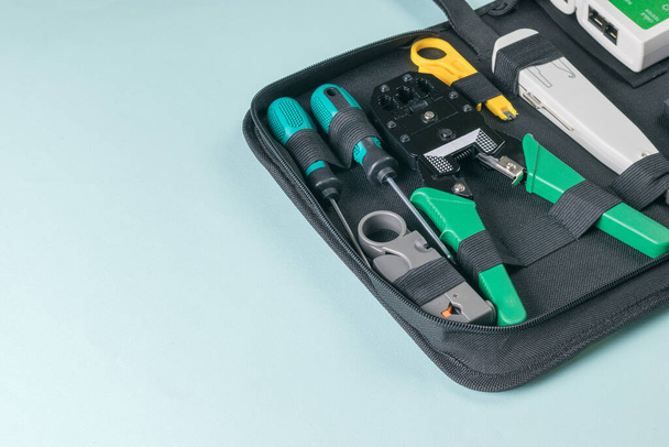 Bag with a tool for working with utp cable on a light background. - Valokuva, kuva
