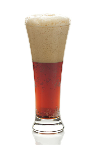 dark beer with the foam in a tall glass isolated on white - Photo, image
