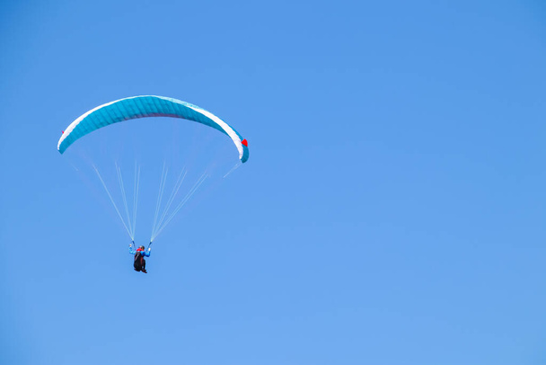 Paraglider soaring in the blue sky. - Photo, image