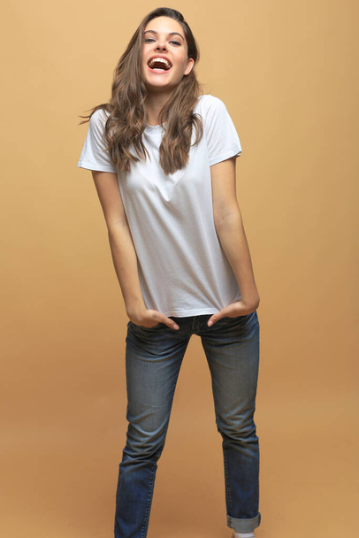 Full length photo of charming young woman in casual wear over beige background - Фото, зображення