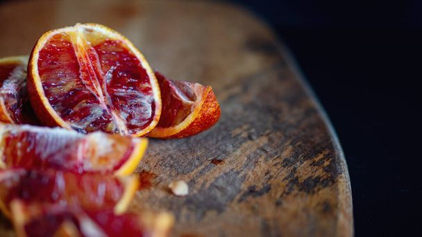 Slices of red oranges on wooden Board - Fotografie, Obrázek