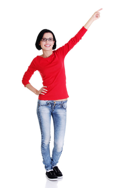 Excited young woman pointing on copy space - Foto, Imagen