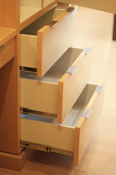 Open the modern cabinet drawer in furniture shop - 写真・画像