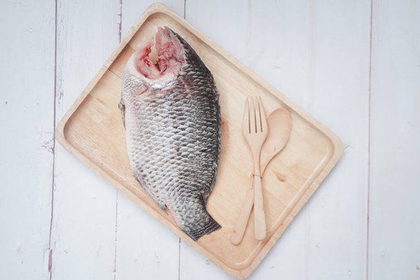 Zavřete syrové ryby tilapie Nilu na dřevěné podnosy připravené k usmažení. Thajský styl potravin - Fotografie, Obrázek